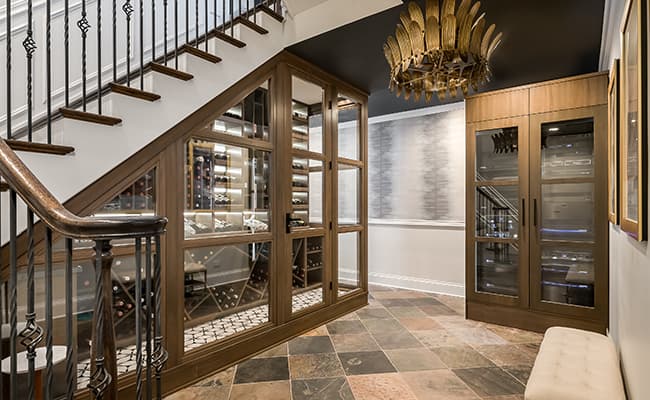 A stylishly finished basement with a comfortable seating area and bar.