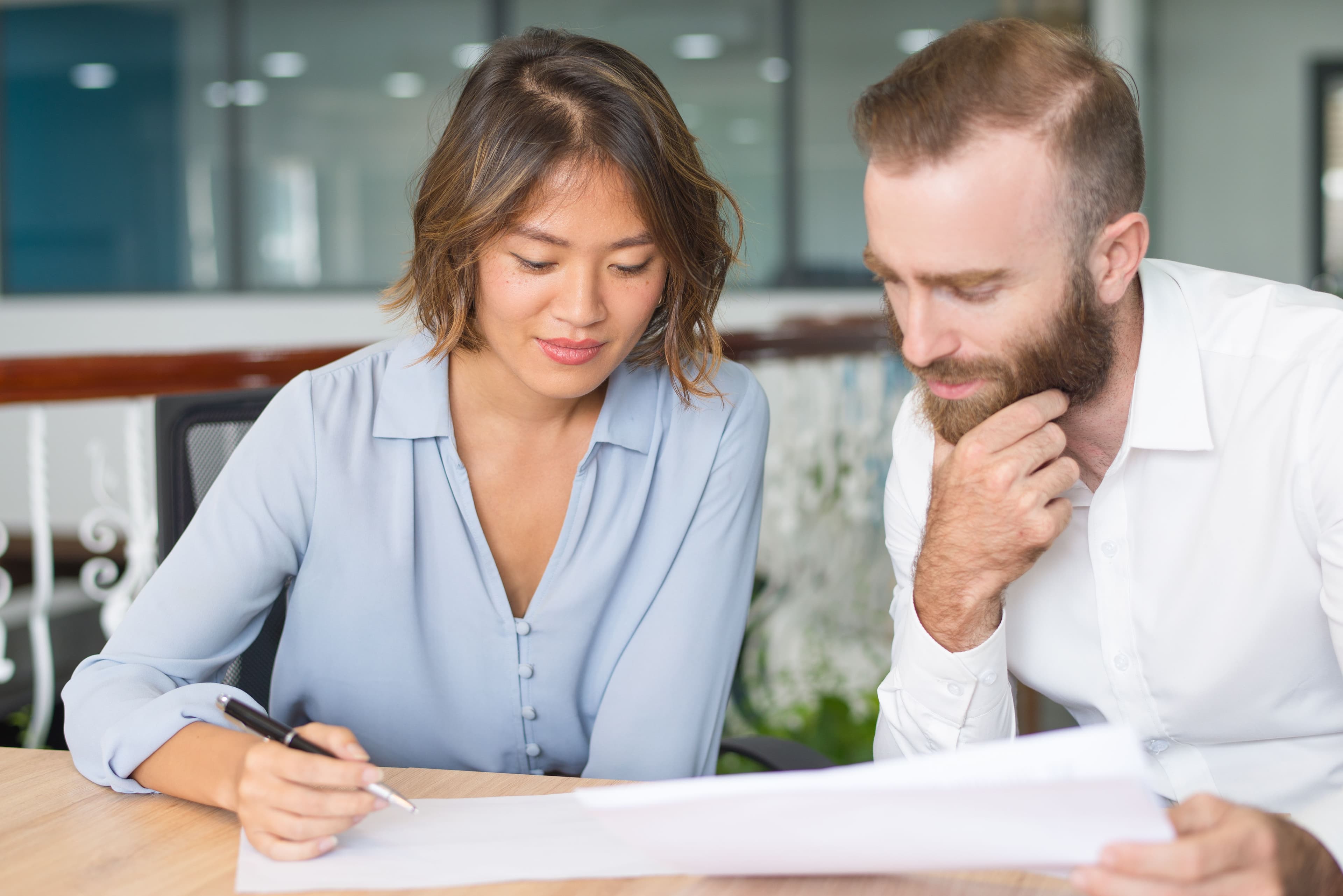 Homeowner reviewing a remodeling contract with a contractor before starting a home renovation project