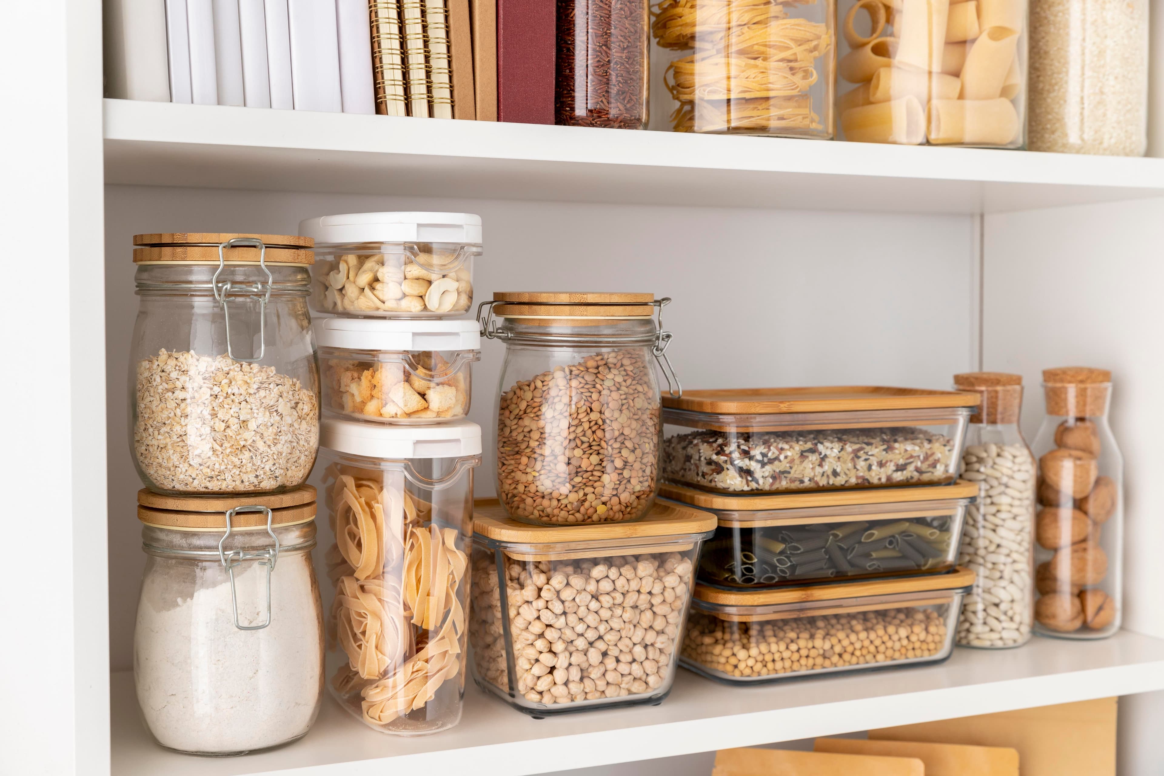 Custom white kitchen with deep drawers, pull-out pantry, built-in organizers, and a large island designed for maximum storage.