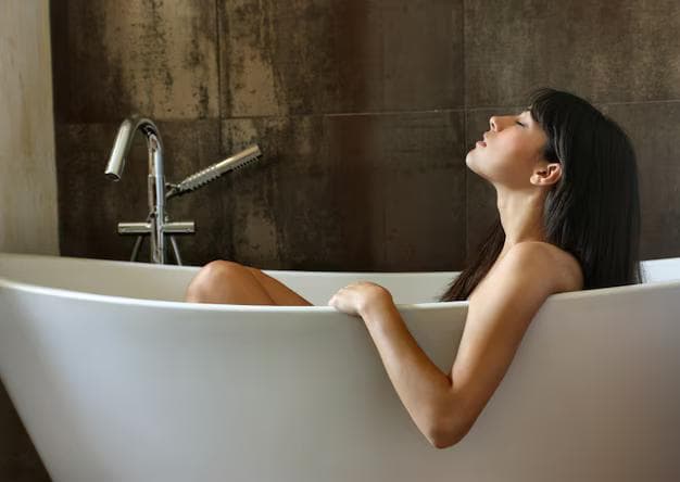 Modern bathroom featuring a walk-in shower beside a freestanding bathtub in a bright, elegant space.