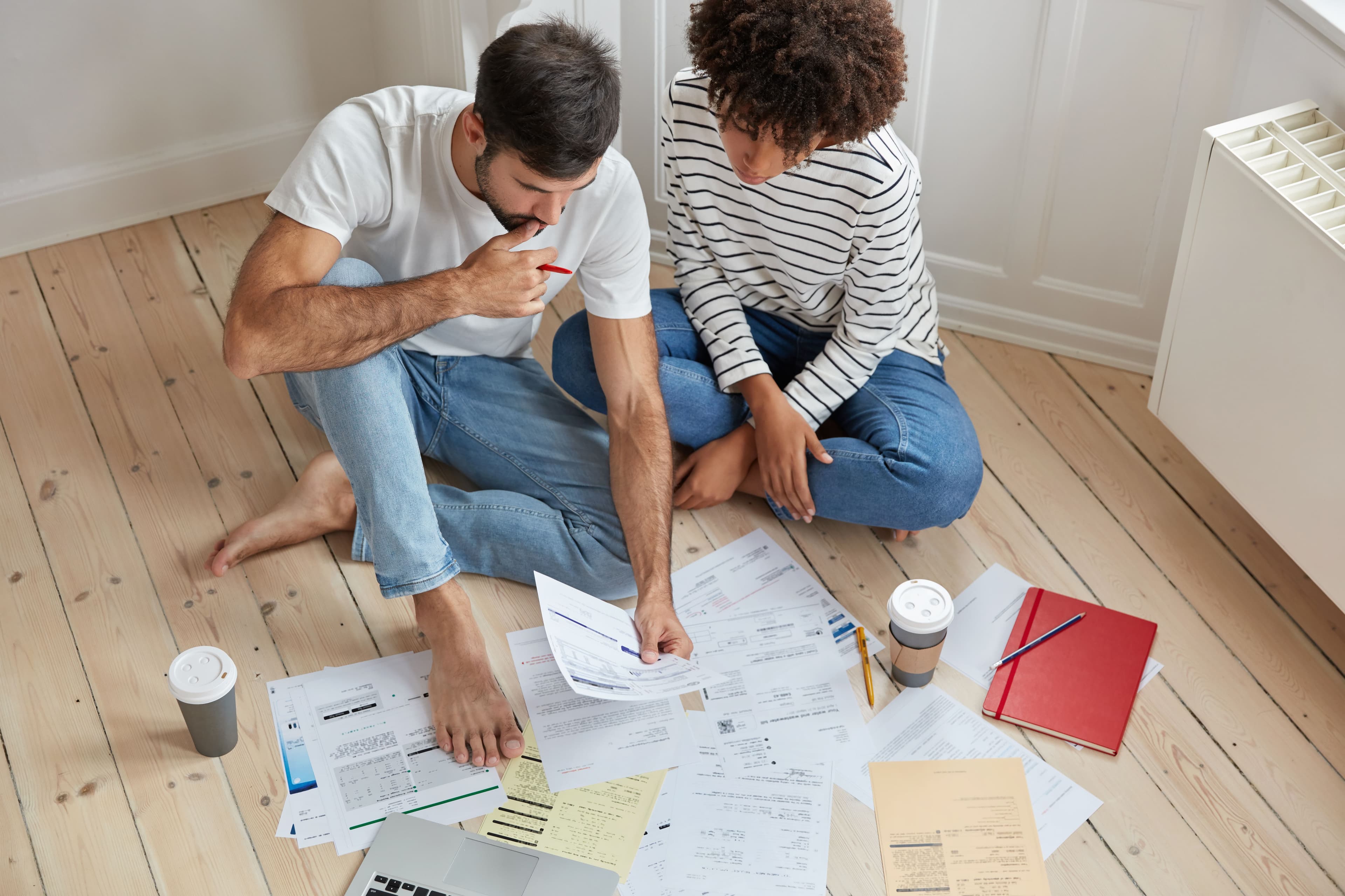 Homeowner and remodeling expert reviewing renovation plans and budget options in a modern kitchen.